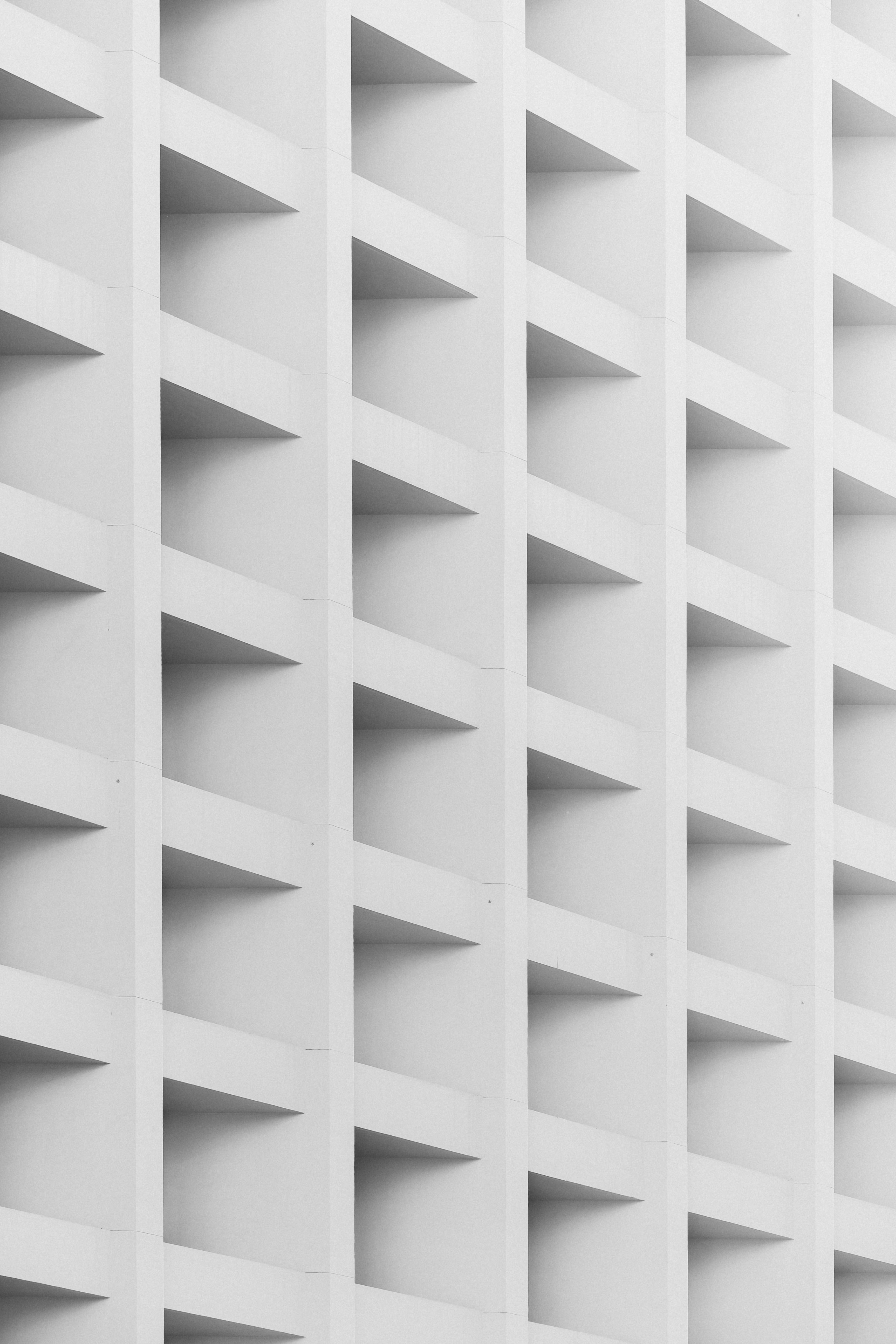 A white building with many shaped squares on the facade